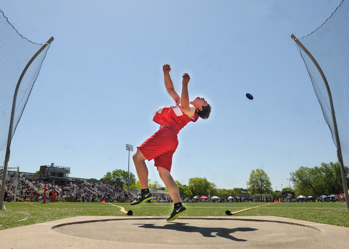 Somerville, MA - Hingham's Brian Sullivan 051212 releases a throw while working his way to victory during competition in the discus throw competition at MSTCA track & field invitational meet at Dilboy Stadium.