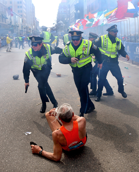 Boston-4/15/13- Boston Police officers Rachel McGuire, Kevin McGill and Javier Pagan react to a second terrorist bomb exploding at the Boston Marathon. They ran after the first bomb exploded next to them near the finish line of the Boston Marathon that knocked down runner Bill Effrig on to Boylston Street.