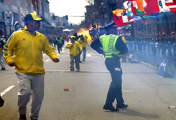 Boston-4/15/13- The second terrorist bomb explodes several blocks from the Boston Marathon finish line as Marathon volunteers and Boston Police react.