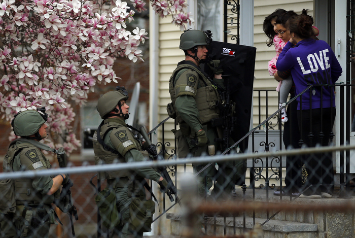 Residents clear out of their homes as police officers search house to house for the second suspect in the Boston Marathon bombings in a neighborhood of Watertown, Massachusetts April 19, 2013. Two explosions hit the Boston Marathon as runners crossed the finish line killing at least three people and injuring over 100 others.