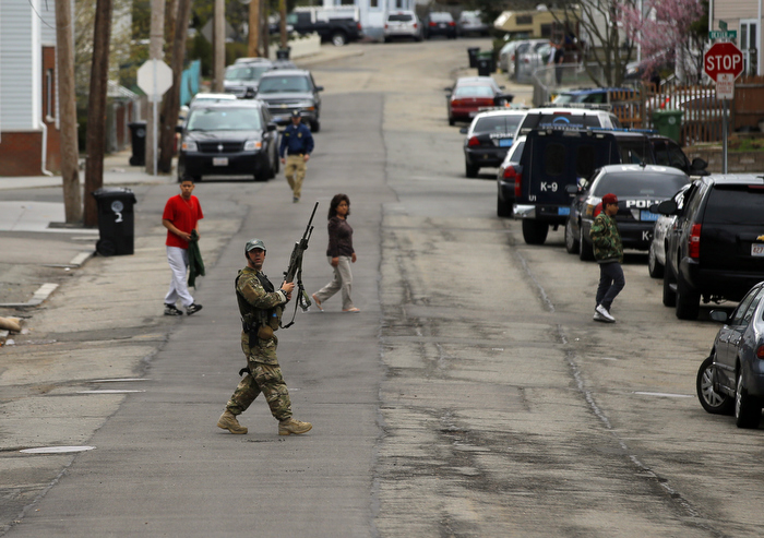 Residents clear out of their homes as police officers search house to house for the second suspect in the Boston Marathon bombings in a neighborhood of Watertown, Massachusetts April 19, 2013. Two explosions hit the Boston Marathon as runners crossed the finish line killing at least three people and injuring over 100 others.