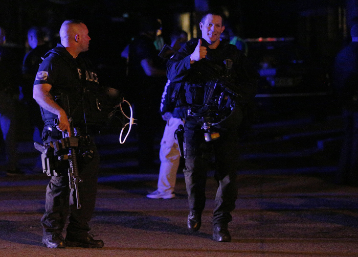 A tactical police officer gives a thumbs up as he emerges from the site where police captured Boston Marathon bombing suspect Dzhokhar Tsarnaev in Watertown, Massachusetts April 19, 2013. Two explosions hit the Boston Marathon as runners crossed the finish line killing at least three people and injuring over 100 others.