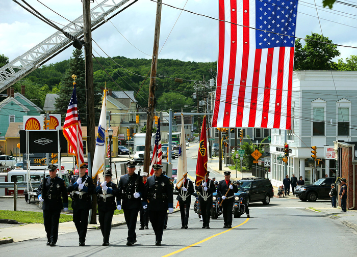 Hudson-06/14/13- A funeral mass was held at Saint Michael Church for former Gov. Paul Cellucci , where friends, family and politicians attended. A procession males it's way from downtown to the church under the fire department flag.