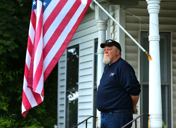 Hudson-06/14/13- A funeral mass was held at Saint Michael Church for former Gov. Paul Cellucci , where friends, family and politicians attended. Resident Jim Rittenhouse watches from across the street from the church on his front steps. "Everybody in town knew him." he said.