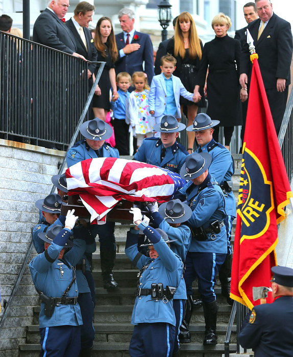 Hudson-06/14/13- A funeral mass was held at Saint Michael Church for former Gov. Paul Cellucci , where friends, family and politicians attended. Cellucci's wife Jan(right short hair) leads the family behind the State Police Pallbearers.