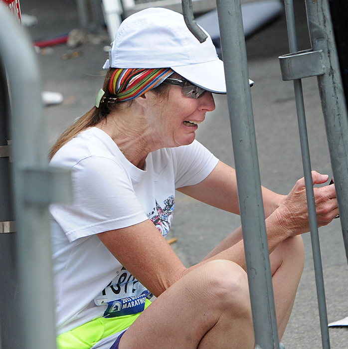 A runner sobs a short distance from the bombings at the Boston Marathon finish line. The explosions put an immediate end to the race as bystanders and emergency responders tended to the injured.