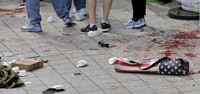 Blood from victims covers the sidewalk on Boylston Street, at the site of an explosion during the 2013 Boston Marathon in Boston.