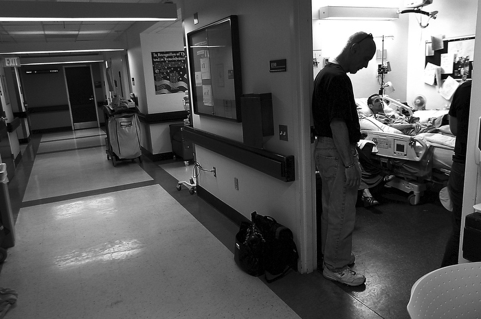An emotional Edward Fucarile stands in the doorway of his son's hospital room. Marc's family is at the hospital more than not, away from young children and their jobs.