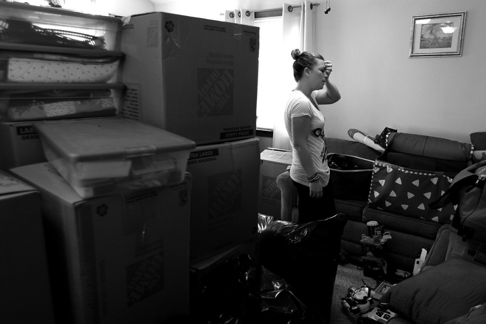 Jen Regan packs their belongings to be moved to their new apartment which is wheelchair accessible. Memories of her former life, and the smell of Marc, have kept her out of their home since the bombing. "It's not like he's dead," she says. "I get nervous that it won't be him. You have to think: What will it be like."