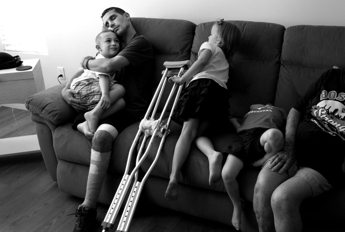 Marc embraces his son Gavin after arriving home. Gavin desperately missed his father and was bewildered by his absence. "When will Daddy come home?" he asked over and over. One night he ripped a Boston Strong poster from a door.
