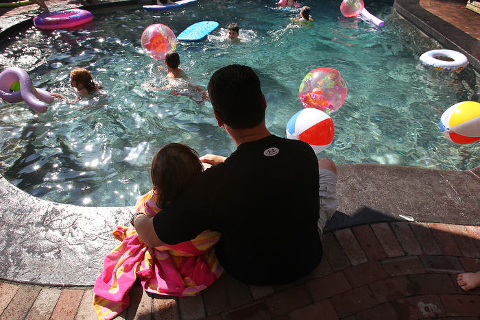 8. Calle's sixth birthday party is moved up by seven weeks as she continues to weaken. A pool party is held at a friend's house. When Calle became too cold and tired to swim, she and her dad, Kevin, watched the other children play.