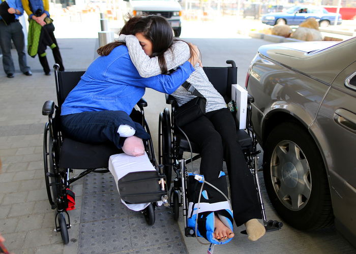 Boston-5/03/13- Boston Marathon bombing survivors Celeste Corcoran from Lowell and her daughter Sydney hug at Spaulding Rehab Hospital as Sydney was discharged. Celeste lost both her legs and Sydney almost died after a massive leg injury tore her femoral artery. Sydney's departure both comforts and unsettles Celeste."if Sydney would of died, I think I would of died with her." Celeste said.