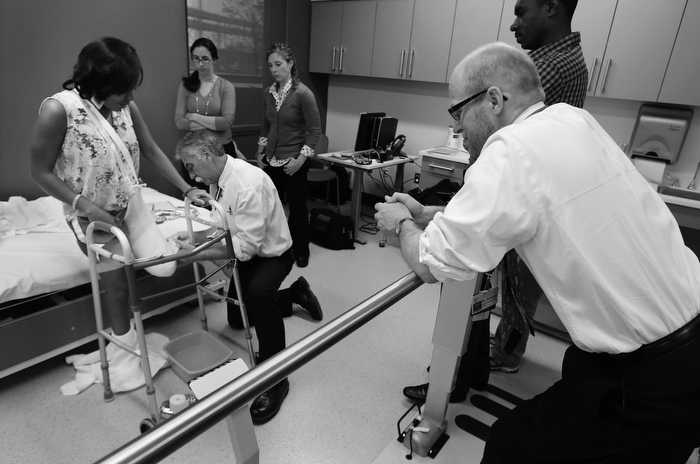 Paul Martino, of United Prosthetics, makes a plaster cast of what remains of Mery Daniel's left leg, as her physician, Dr. David Crandell, right, watches at the Spaulding Rehabilitation Hospital in Boston, Wednesday, May 29, 2013. Crandell, a physiatrist at Spaulding, has treated fifteen of the sixteen marathon amputees. Behind Crandell is Mery's husband, Richardson Daniel.