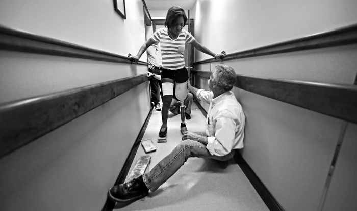 Paul Martino, of United Prosthetics, helps steady Mery Daniel, as she takes her first step since losing her left leg in the Boston Marathon bombings, while getting fitted for a prosthetic leg at the company in the Dorchester neighborhood of Boston, Tuesday, June 4, 2013. Martino's family business has been helping amputees for about 100 years, including many of the bombing survivors.