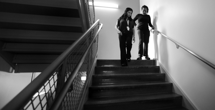 Mery Daniel, a Boston Marathon bombing survivor, steadies herself as she works out while climbing up and down stairs with her therapist Urvashi Chogle, left, at the Spaulding Rehabilitation Hospital, Friday, Sept. 27, 2013, in Boston. Five month after the blast that took her left leg from her, Daniel is finally able to walk on her own again.