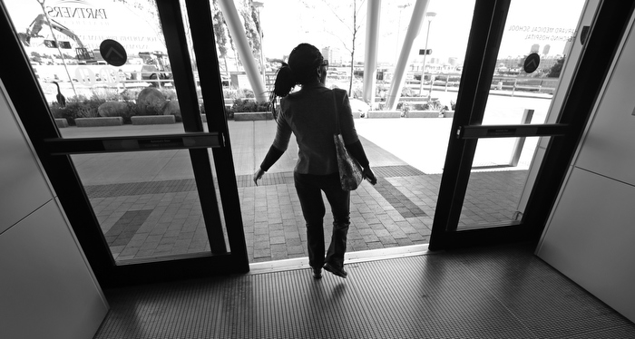 Mery Daniel, a Boston Marathon bombing survivor, walks out the front door at Spaulding Rehabilitation Hospital following a physical therapy session, Friday, Sept. 27, 2013, in Boston. Daniel, whose heart stopped twice in the emergency room while being treated and lost much of her left leg in the race day blast, has begun to slowly regain parts of her mobility and independence.