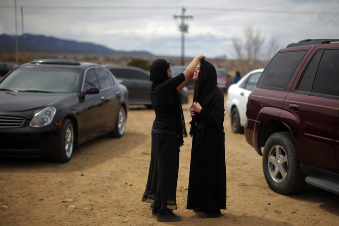 Girls, dressed for the role of Veronica, fix each other's veils between Good Friday religious ceremonies at the Morada de Talpa in Talpa, New Mexico March 29, 2013. A morada is an unsanctified chapel where the Hermanos, a centuries old lay Catholic group of men in northern New Mexico, worship.