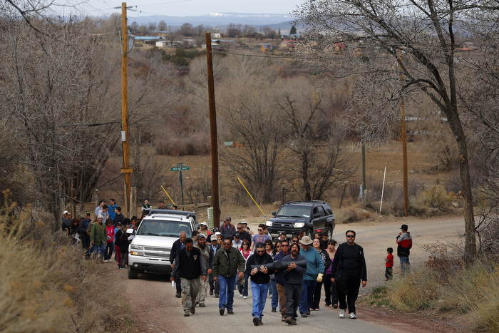 Men carrying a large cross lead a Good Friday pilgrimage in Ranchos de Taos, New Mexico March 29, 2013. Several hundred followers of the Catholic Church walked a pilgrimage celebrating the Stations of the Cross from the San Francisco de Asis Catholic Church, through Ranchos de Taos and the remote village Talpa, New Mexico.