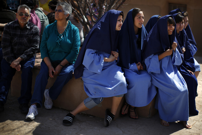 Students playing the role of the women of Jerusalem, the eighth Station, wait to begin a re-enactment of the Stations of the Cross at the Sanctuary of Chimayo in Chimayo, New Mexico March 28, 2013. The students are part of a youth group from Our Lady of Sorrows church in Bernalillo, New Mexico which re-enacts the Stations of the Cross every year.