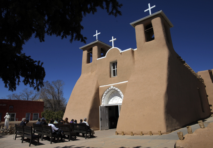 Parishioners sit in pews for Easter Mass outside the full San Francisco de Asis Catholic Church in Ranchos de Taos, New Mexico March 31, 2013.