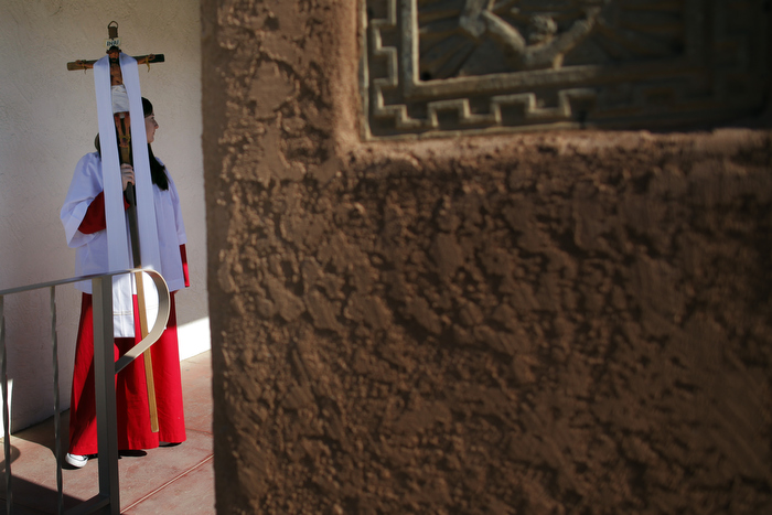 A girl carries out the crucifix after Easter Mass at Our Lady of Guadalupe Catholic Church in Taos, New Mexico March 31, 2013.