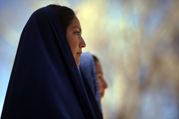 Students playing the role of the women of Jerusalem, the eighth Station, wait to begin a re-enactment of the Stations of the Cross at the Sanctuary of Chimayo in Chimayo, New Mexico March 28, 2013. The students are part of a youth group from Our Lady of Sorrows church in Bernalillo, New Mexico which re-enacts the Stations of the Cross every year.
