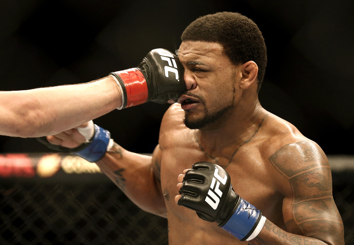 Aug 17, 2013; Boston, MA, USA; Joe Lauzon, not seen, lands a punch on the face of Michael Johnson during a UFC Lightweight match at the TD Garden. Johnson won by judges decision.