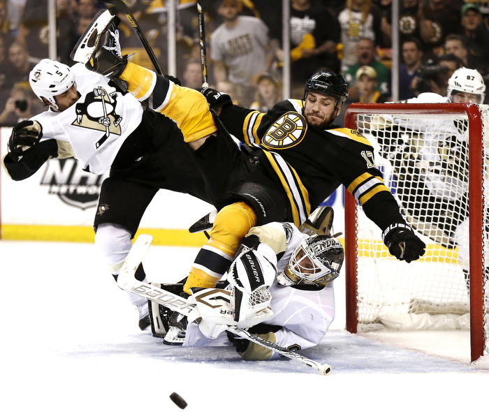 Boston Bruins' Milan Lucic crashes into the Pittsburgh Penguins Goalie during Game 3 of their NHL Eastern Conference finals hockey playoff series in Boston, Massachusetts June 5, 2013.