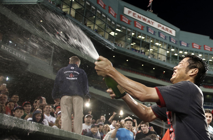 Sep 20, 2013; Boston, MA, USA; Boston Red Sox relief pitcher Koji Uehara (19) of Japan sprays champagne on the fans after they clinched the AL East with a win over the Toronto Blue Jays at Fenway Park.