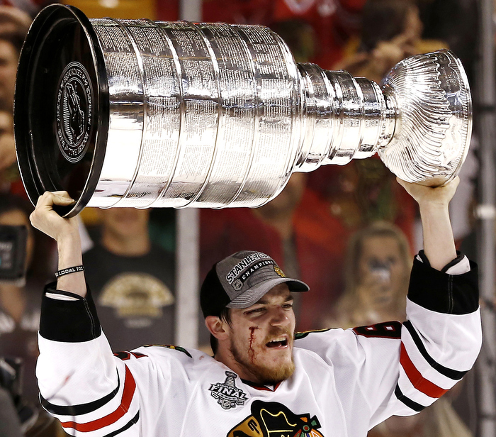 Chicago Blackhawks Andrew Shaw raises the Stanley Cup after Game 6 of their NHL Stanley Cup Finals hockey series in Boston, Massachusetts, June 24, 2013.