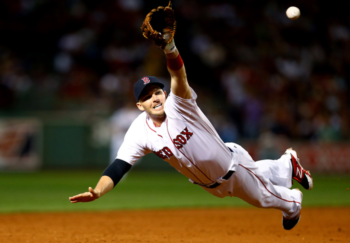 Stephen Drew #7 of the Boston Red Sox dives but comes up short for a ball hit down the third base line against the New York Yankees during the game on September 15, 2013 at Fenway Park in Boston, Massachusetts.