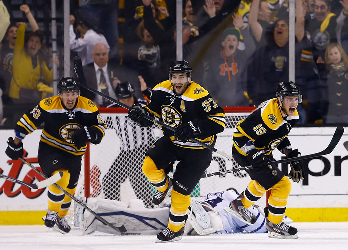 Patrice Bergeron #37, Tyler Seguin #19, and Brad Marchand #63 of the Boston Bruins celebrate following Bergeron's game-winning overtime goal against the Toronto Maple Leafs in Game Seven of the Eastern Conference Quarterfinals during the 2013 NHL Stanley Cup Playoffs on May 13, 2013 at TD Garden in Boston, Massachusetts.
