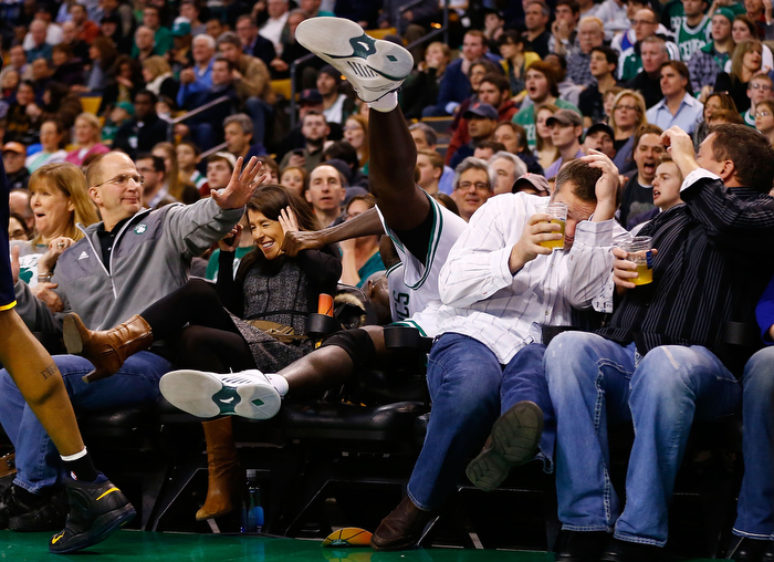 Kevin Garnett #5 of the Boston Celtics spills into the fans sitting in the court side seats before flipping over a chair after attempting to grab a loose ball against the Indiana Pacers during the game on January 4, 2013 at TD Garden in Boston, Massachusetts.