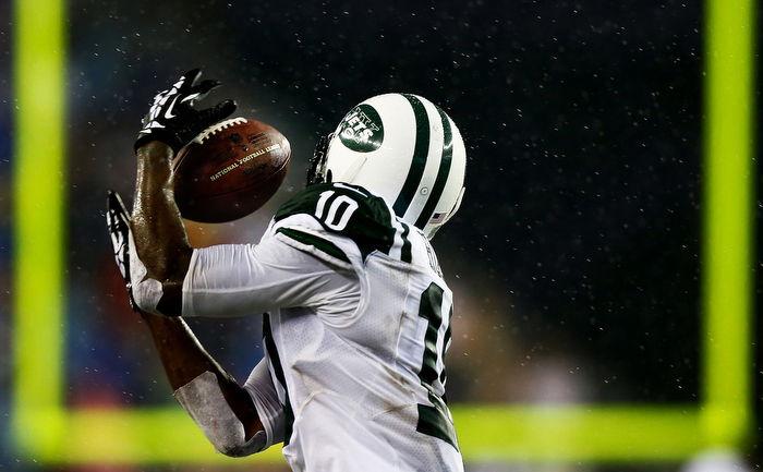 Santonio Holmes #10 of the New York Jets catches a pass against the New England Patriots in the second half during the game at Gillette Stadium on September 12, 2013 in Foxboro, Massachusetts.