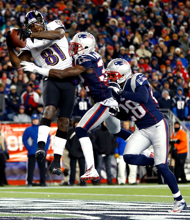 Anquan Boldin #81 of the Baltimore Ravens scores a touchdown passed by Joe Flacco #5 in the fourth quarter against Devin McCourty #32 of the New England Patriots during the 2013 AFC Championship game at Gillette Stadium on January 20, 2013 in Foxboro, Massachusetts.