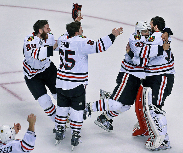 After the final horn sounded in Chicago's incredible last minute come back victory, Johnny Oduya leaps into the arms of goalie Corey Crawford, as other teammates rush to join the party.