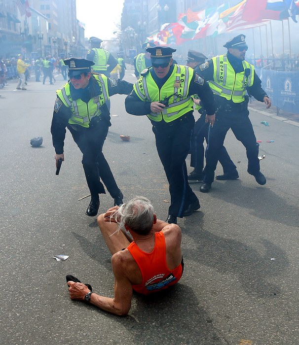 Boston-4/15/13- Boston Police officers Rachel McGuire, Kevin McGill and Javier Pagan react to a second terrorist bomb exploding at the Boston Marathon. The first bomb knocked down runner Bill Effrig on Boylston Street near the finish line.