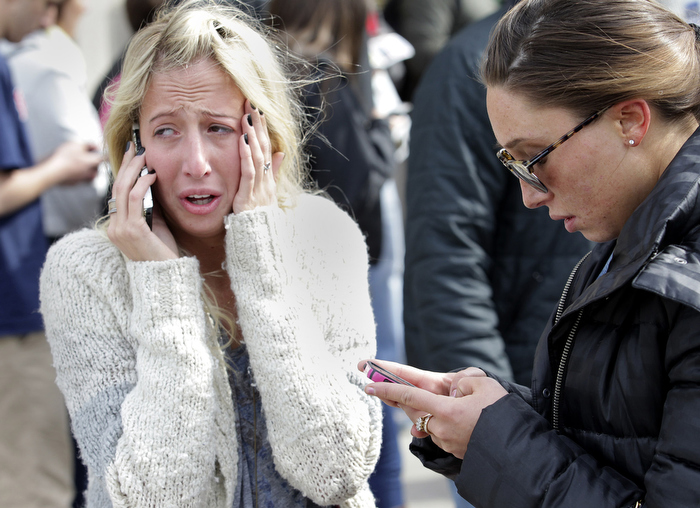 Boston, MA - 4/15/13-Women desperate to hear from loved ones after the explosions at the Boston Marathon can't enter the scene at Boylston and Mass Ave.