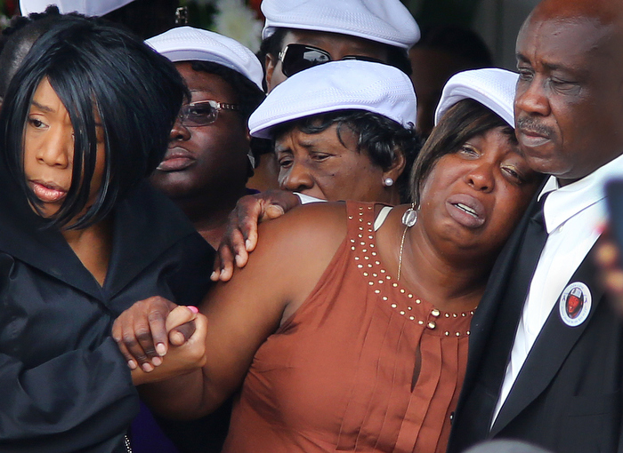 Boston-06/29/13- A funeral service was held for Odin Lloyd at the Holy Spirit Church in Mattapan. His mother, Ursula Ward is helped after the service by his sister Olivia Thibou. Lloyd was allegedly shot to death by former Patriots player Aaron Hernandez.