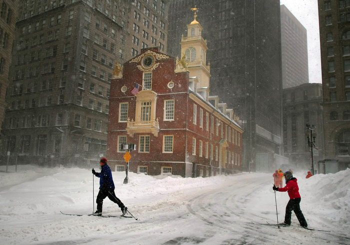 Boston-02/09/13- People began to dugout from the nearly two feet of snow from the blizzard. Two people ski along Congress Street past the Old State House where it appeared to be a ghost town with vehicle traffic banned.
