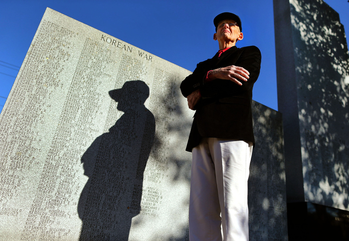 Mansfield-10/25/13-- Earl Austin is a Korean War vet and wrote a book about Mansfield servicemen who died in wartime. He stands at the town war memorial.