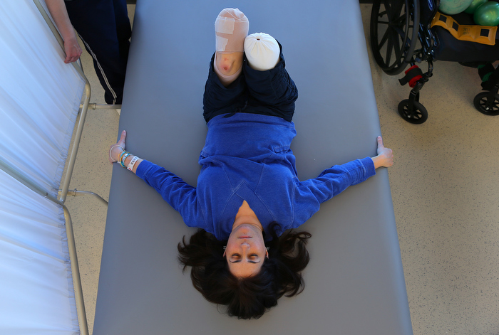 Boston-5/03/13-Celeste Corcoran worked hard in physical therapy doing leg lifts at Spaulding Rehab Hospital. She had to wait for her legs to heal before getting fitted for prosthetics. She was determined at this point to return to "the new normal" as she called it.
