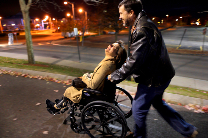 Lowell-11/9/13- Kevin and Celeste Corcoran make their way to the Tsongas Arena to an event to honor victims and first responders of the Boston Marathon. Celeste was tired from being on her legs all day and was wheeled the long distance from the parking lot.