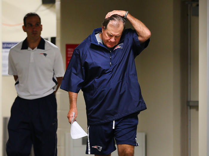 Foxborough-07/24/13 _ New England Patriots head coach Bill Belichick walks into a press conference to speak about Aaron Hernandez at Gillette Stadium as training camp is set to open. It's the first time he talked about the alleged murder committed by former Patriots player Hernandez.