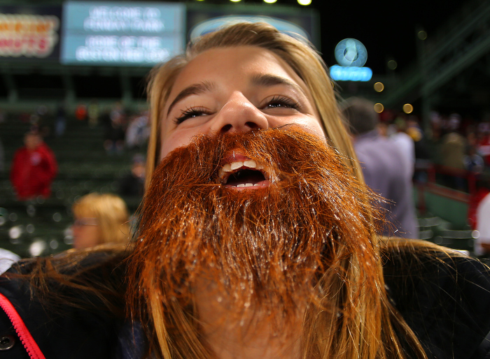 Boston-10/19/13-- ALCS game 6 Red Sox vs Tigers, Sox fan Kacie Smith,14 from Chicopee watches batting practice from the centerfield bleachers wearing a beard to honor the Red Sox.