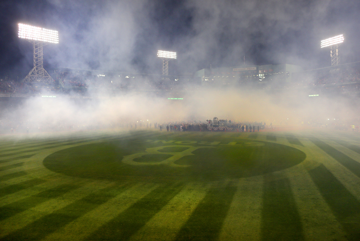 Boston-10/30/13--World Series game 6- Smoke from fireworks blankets the field at the end of the game, during the World Series trophy presentation in the infield, as B -Strong is legible again on the outfield grass.