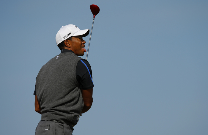 Tiger Woods of the U.S. watches his tee shot on the sixth hole during the third round of the British Open golf championship at Muirfield in Scotland July 20, 2013.