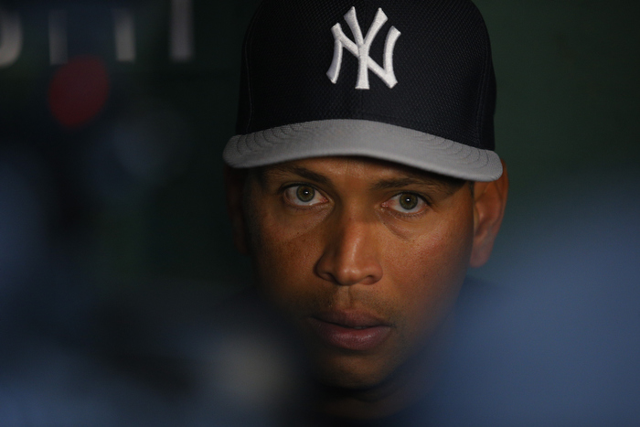 New York Yankees third baseman Alex Rodriguez talks to reporters in the visitors dugout before the Yankees' American League baseball game against the Boston Red Sox at Fenway Park in Boston, Massachusetts August 16, 2013.