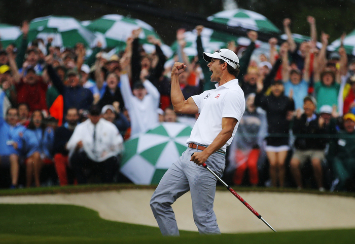 Adam Scott of Australia celebrates sinking a birdie putt on the 18th green during final round play in the 2013 Masters golf tournament at the Augusta National Golf Club in Augusta, Georgia, April 14, 2013.