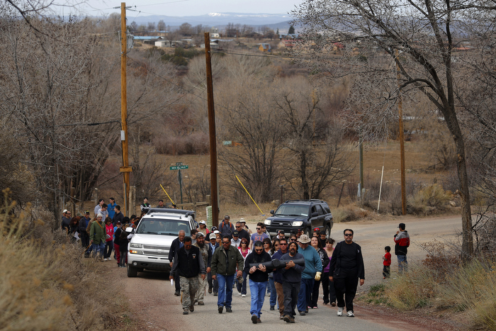 Men carrying a large cross lead a Good Friday pilgrimage in Ranchos de Taos, New Mexico March 29, 2013. Several hundred followers of the Catholic Church walked a pilgrimage celebrating the Stations of the Cross from the San Francisco de Asis Catholic Church, through Ranchos de Taos and the remote village Talpa, New Mexico.